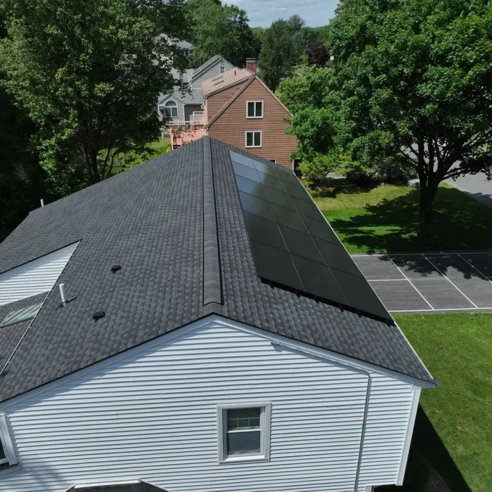 Aerial view of a Completed Solar Roofing Solution project on a shingled roof in Framingham, MA
