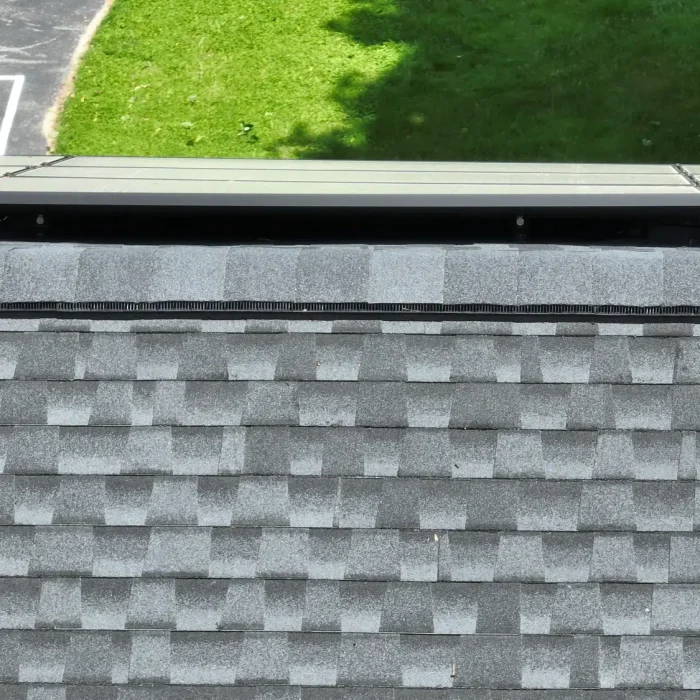 Solar Panel Installation set up on a slanted shingled rooftop in Framingham, MA by Golden Group Roofing