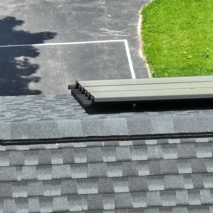 Solar Panel Installation set up on a slanted shingled rooftop in Framingham, MA by Golden Group Roofing