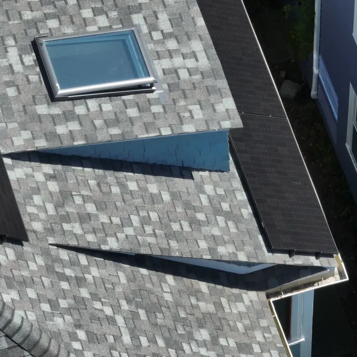 Aerial view of a Completed Solar Roofing Solution project on a shingled roof in Newton, Massachusetts