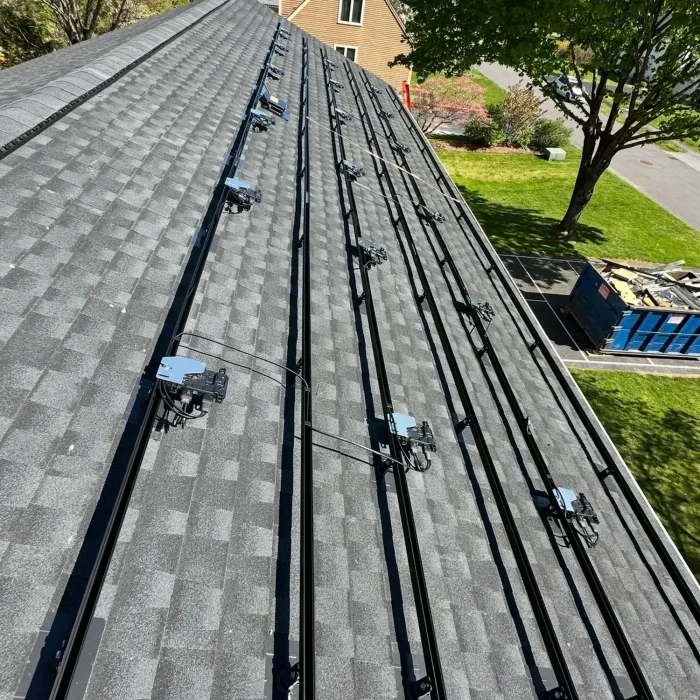 Installing rails and foundation for solar panels to be installed on a residential home in Westborough, MA on a slanted rooftop